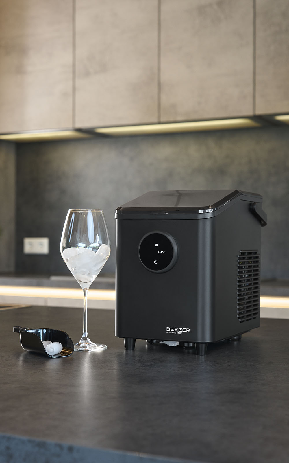 BEEZER IceCube mini on a modern kitchen countertop beside a chilled drink